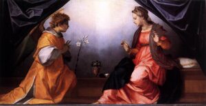 右边的圣母玛利亚穿着红色的衣服，而左边的天使和她说话(橙色的衣服)。