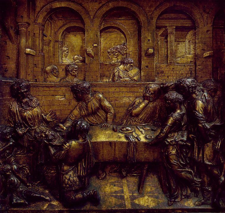 希律王的宴会natello, 1423-1427: A bronze piece carved on a flat surface, the figures are hard to make out.